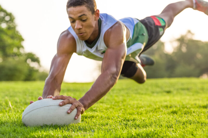 Rugby player scoring a try